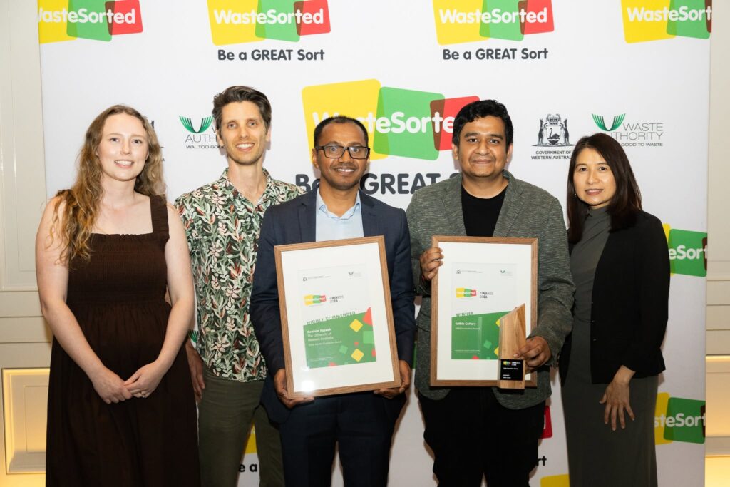 Edible Cutlery team with their award in front of the WasteSorted backdrop